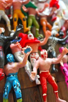 many small toy figurines are lined up on a table