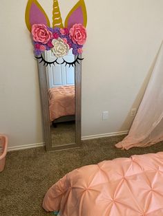 there is a mirror with a unicorn head on it in the corner of this room