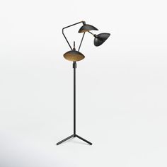 a black lamp with two lights on it and a tripod light next to it