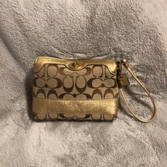 Beautiful Never Used Coach Signature Wristlet, Tan With Gold Accents Coach Gold Rectangular Wristlet, Gold Rectangular Coach Wristlet, Elegant Gold Coach Wristlet, Gold Rectangular Wristlet For Gifts, Coach Gold Clutch Wristlet, Gold Coach Clutch Wristlet, Gold Wristlet With Wrist Strap For Everyday Use, Coach Gold Wristlet For Everyday Use, Chic Coach Clutch Wristlet