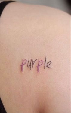 the word purple written in cursive writing on someone's upper back shoulder