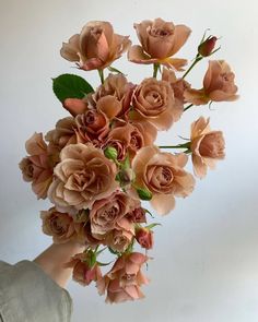 a person holding a bouquet of flowers in their hand