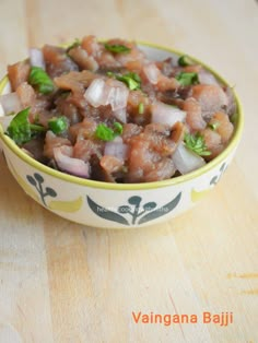 a bowl filled with food sitting on top of a wooden table