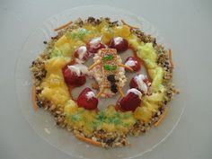 a white plate topped with fruit and veggies on top of rice krispy kreme