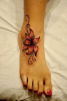 a woman's foot with a flower tattoo on it