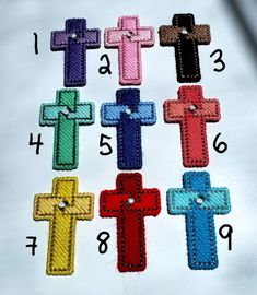 the cross is made out of different colors and has stitchs on each one side