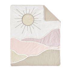 a pink and white blanket with a sun on it