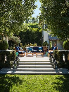 an outdoor living area with couches and chairs