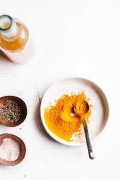 there are three different types of spices on the plate and in bowls next to each other