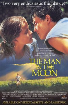 a movie poster for the man in the moon with two young people kissing each other