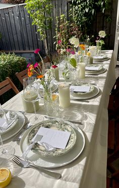 a long table with plates and glasses on it