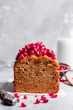 a slice of cake with pomegranate on top