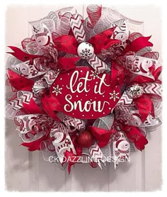 a red and white wreath that says let it snow