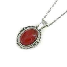 "Stunning real carnelian oval pendant necklace showcases natural polished carnelian gemstone. Carnelian is dark reddish brown gemstone and also known as cornelian.  The dark red stone is set in petite lead and nickel free cute designer pendant with attached bail. Sturdy yet lightweight stainless steel chain with lobster clasp ensures a secure and comfortable fit. Measurements(approx, see 3rd photo) Chain Length:18\" Pendant:1 \" Stone:18x13 mm Please Note: Natural dyed carnelian, may have some marking owing to the genuine natural properties of the stone." Luxury Carnelian Jewelry With Polished Finish, Carnelian Oval Pendant Necklace With Gemstone, Luxury Red Oval Pendant Jewelry, Oval Red Carnelian Jewelry, Red Oval Carnelian Necklace, Red Carnelian Oval Necklace, Carnelian Gemstone Round Pendant Jewelry, Carnelian Pendant With Natural Stones, Red Stone Pendant