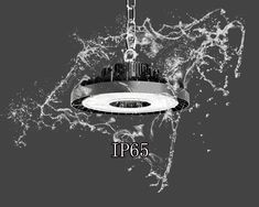 a black and white photo of a light fixture with water splashing on it's side