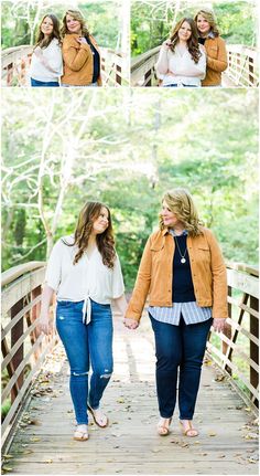 two women holding hands while walking across a bridge