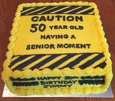 a birthday cake that says caution 50 year old having a senior moment