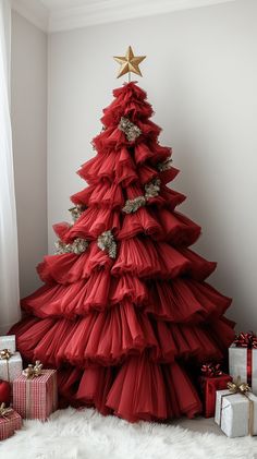 a red christmas tree with gold stars on top