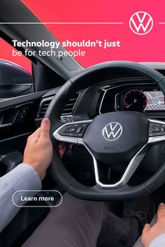 the interior of a volkswagen car with technology on display and people sitting in the driver's seat