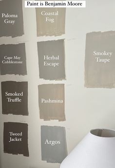 the walls are painted in different shades of gray and white, with names on them