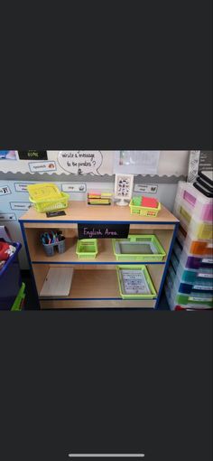 a desk with several bins on it and some bookshelves in the background