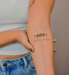 a woman's arm with three phases of the moon tattoo on her left side