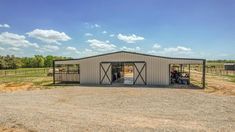 a large metal building with two open doors