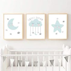 two posters on the wall above a crib in a baby's nursery room