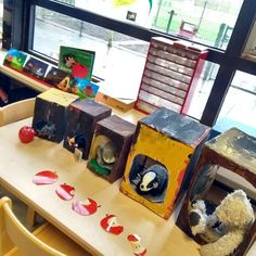 stuffed animals are sitting in small boxes on a table