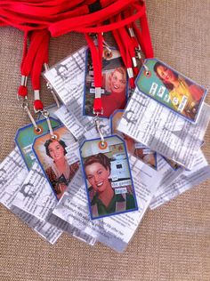 several id badges are attached to a red cord