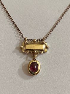 This solid 9 ct yellow gold bar necklace features a rhodolite cabochon garnet set in solid 9 ct yellow gold . It's bohemian perfectly imperfect charm is unique , it has been handmade and designed in a small artisan studio . The chain is gold plated silver . Kei Jewelry, Gold Bar Necklace, Garnet Necklace, Stacked Jewelry, Rhodolite Garnet, Gold Bar, Perfectly Imperfect