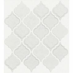 a white tile wall with an intricate pattern on the top and bottom, in shades of gray