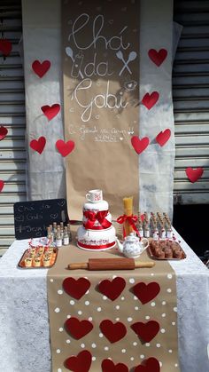 a table topped with a cake covered in hearts