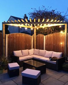 an outdoor seating area is lit up with string lights