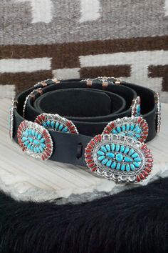 This Sleeping Beauty turquoise, coral and sterling silver squash blossom, concho belt, earrings, pin/ pendant, bracelets, and rings set was made by Navajo silversmith Justina Wilson. The back is signed JW and stamped sterling.Squash BlossomLength: 26 1/2"Naja Height: 3"Naja Width: 3"Blossom Length: 1 1/8"Blossom Width: 2 1/8" Concho Belt Belt Length: up to 60" Belt Buckle Length: 3 1/4" Belt Buckle Width: 2 1/8" Concho Length: 2 1/2" Concho Width: 1 3/4" EarringsLength: 1 1/2"Width: 1 1/8"Pin/ P Traditional Turquoise Concho Jewelry, Traditional Turquoise Jewelry With Concho, Traditional Hand Tooled Turquoise Jewelry, Traditional Hand-tooled Turquoise Jewelry, Bohemian Hand Tooled Jewelry For Rodeo, Southwestern Hand-tooled Jewelry For Ranch, Turquoise Concho Jewelry For Rodeo, Bohemian Concho Jewelry For Rodeo, Artisan Jewelry With Concho For Western-themed Events