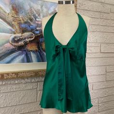 Measurements Are Approximate And Taken With Garment Laying Flat. 100% Silk Hand Wash Line Dry Charmeuse Silk Lined Bustline Halter Style Emerald Green V-Neckline Sash Front Invisible Side Zipper Closure Hook & Eye Closure Side Length 17” Armpit To Armpit 20” Green Silk V-neck Top, Elegant Green V-neck Camisole, Elegant Green Tank Top, Green V-neck Tank Top For Night Out, Chic Green Tank Blouse, Chic Green Cami Blouse, Green Cami Top For Night Out, Chic Green Cami Halter Top, Chic Green Camisole Tops