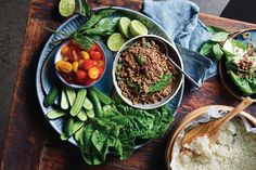 a table topped with plates of food and bowls filled with different types of vegetables on top of each plate