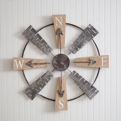 a metal and wood clock with letters on it