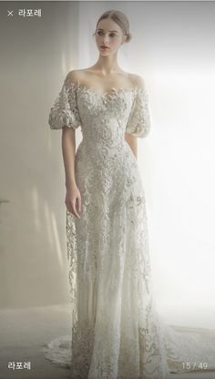 a woman in an off the shoulder wedding dress