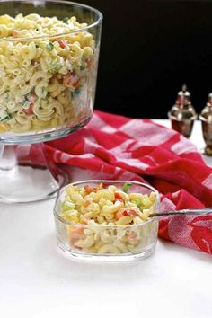 two bowls filled with macaroni salad on top of a table