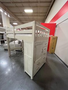 a bunk bed and dresser in a warehouse