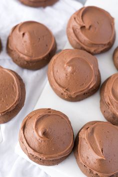 chocolate cupcakes with frosting on white paper