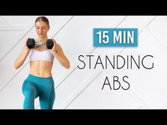 a woman is holding two dumbbells in front of her face with the words 15 min standing abs