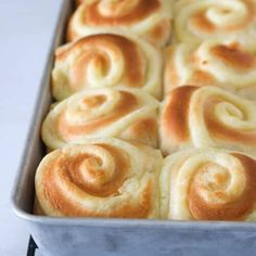 a pan filled with rolls sitting on top of a table