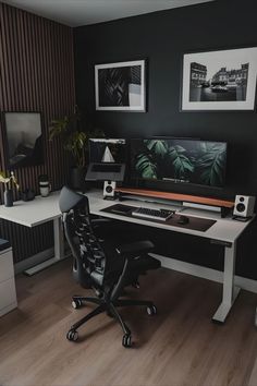 there is a desk with two computer monitors and a chair in front of the desk