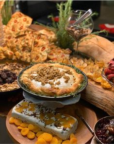 a table topped with lots of pies and other desserts next to each other