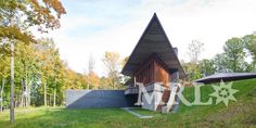 the house is made out of wood and has stairs leading up to it's roof