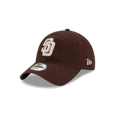 The San Diego Padres Core Classic Alternate 9TWENTY Adjustable Cap features an embroidered Padres logo at the front panels with a woven tab displaying the team logo on a D-Ring closure at the rear. Brown Hats For Baseball Season Sports Events, Brown Baseball Cap For Baseball Season, Brown Sports Hat With Curved Bill, Collegiate Hats With Logo Patch For Game Day, Sporty Brown Hats For Sports, Sporty Brown Sports Hats, Casual Brown Baseball Cap For Sports Events, Brown Cotton Baseball Cap For Sports, Collegiate Hats With Logo Patch For Sports Events