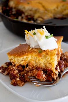 a piece of pie on a white plate with a fork in front of the pie