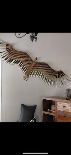 an eagle sculpture hanging on the wall above a desk